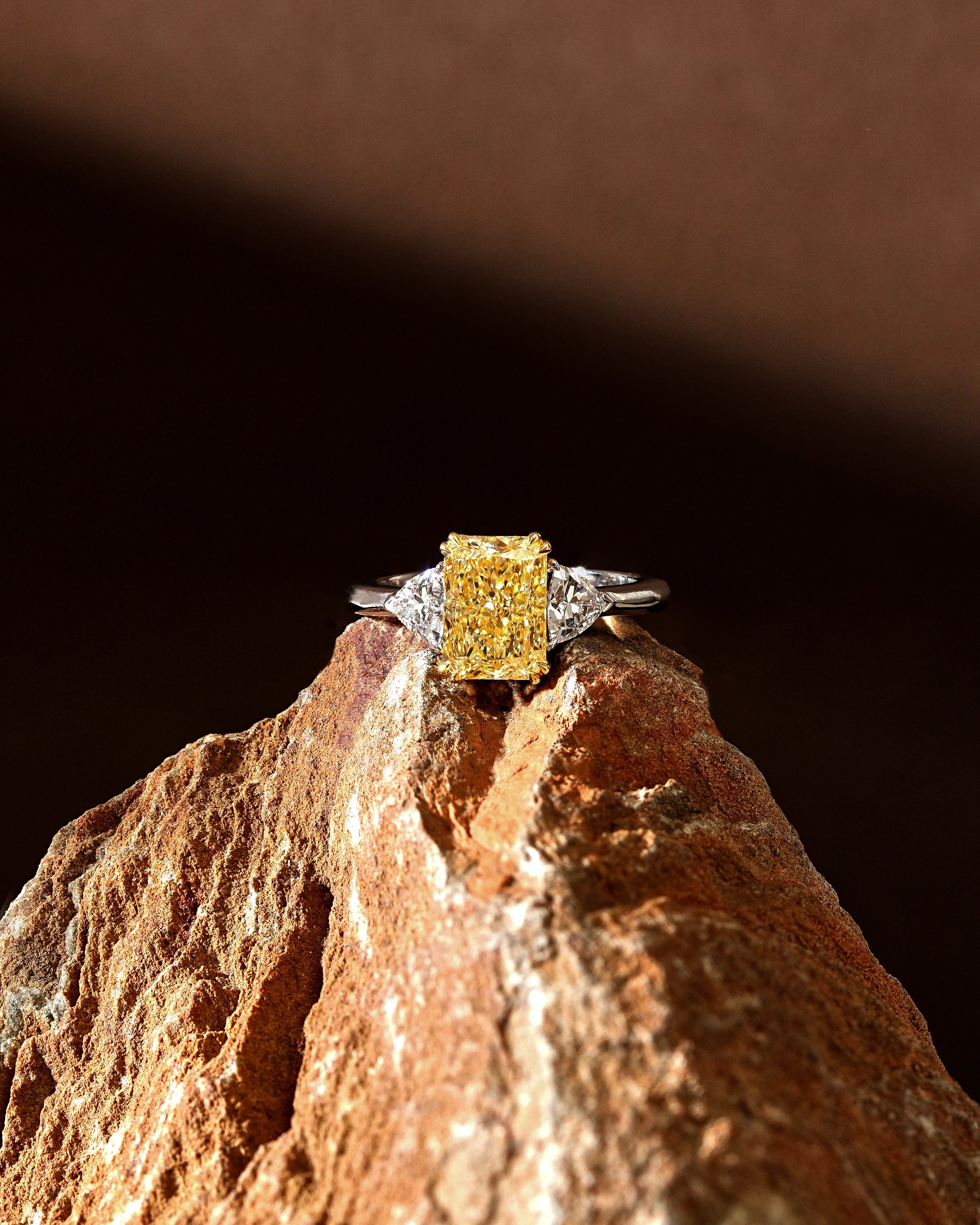 The Reserve 2.5 Carat Fancy Yellow Radiant Cut Diamond with Trillion Cut Three Stone Ring