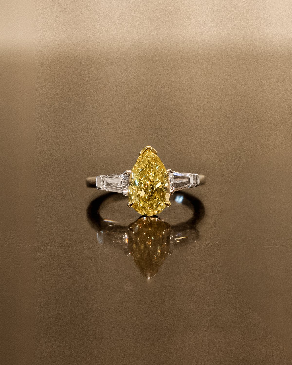 The Reserve 2.5 Carat Fancy Yellow Pear Cut Diamond with Tapered Cut Three Stone Ring