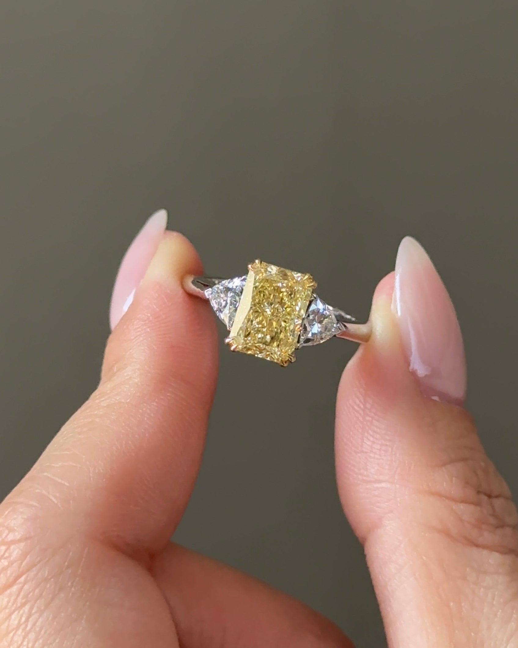 The Reserve 2.5 Carat Fancy Yellow Radiant Cut Diamond with Trillion Cut Three Stone Ring