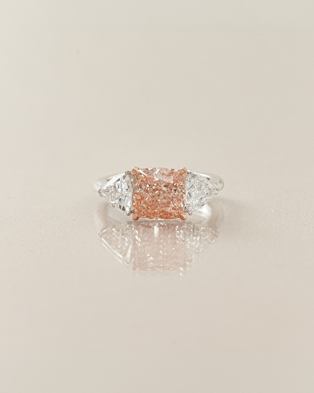 The Reserve II 3 carats Fancy Vivid Pink Cushion Cut Diamond Three Stone Ring